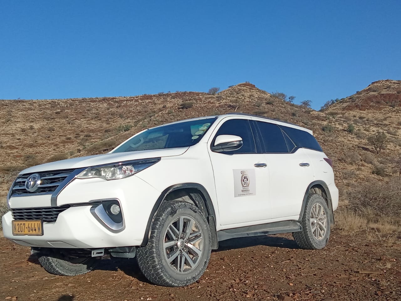 Safari vehicle near rocky mountains